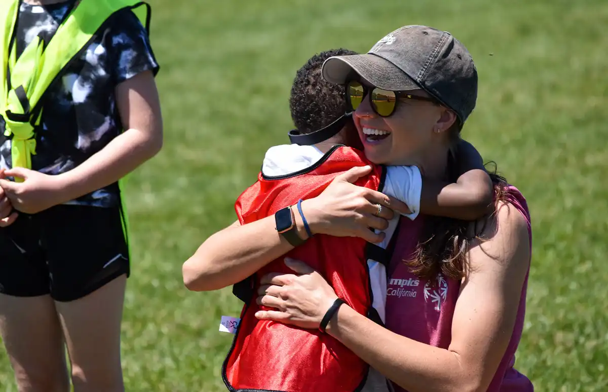 Young Athletes Fair - Woman Hugging Child